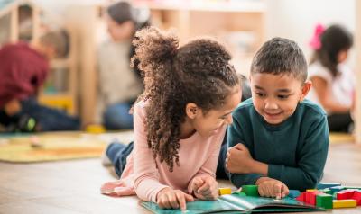 two children on the floor reading