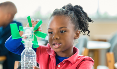 A child working on a project in a classroom
