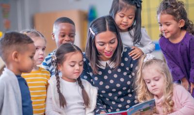 Image of a teacher reading to a group of students