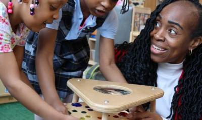 Teacher working with students on a project