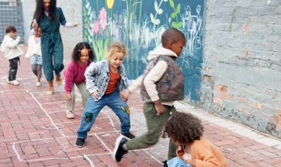 A group of kids playing hopscotch outside