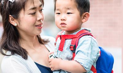 Mother holding her son at school