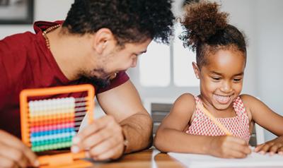 Father and daughter doing math activities