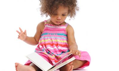 kindergartner girl reading a book 