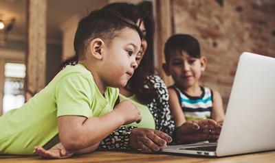 2 children with parent doing a zoom course