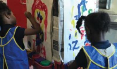 Two girls painting in classroom