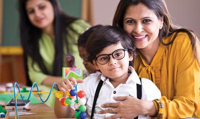 Teacher and student posing for an image while playing and doing puzzles