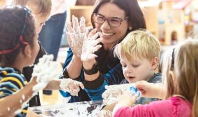 Teacher working on a project with students in a classroom