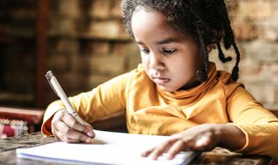 Girl writing on paper