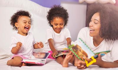 Mother reading with toddler girls