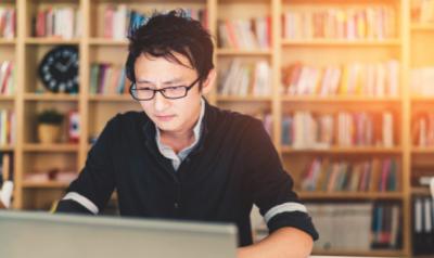 Man working on laptop in the library