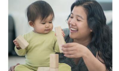 Infant and mother playing with blocks
