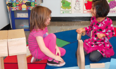 Two girls playing in block center