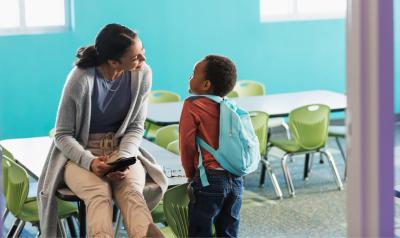 A teacher converses with her student.