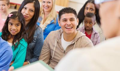 Adults and children in a learning environment.