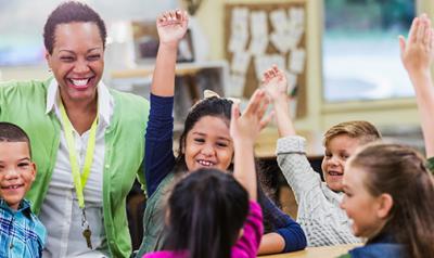 Educator playfully raising hand with children