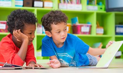 Two children reading on the floor