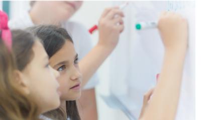 children writing on the white board