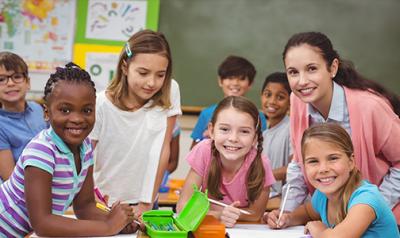 A teacher with a group of young children.