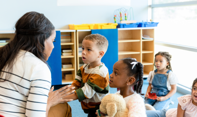 A teacher talking to a group of students.