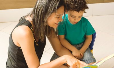 a parent or teacher reading with a child