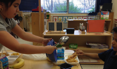 children helping each other in class