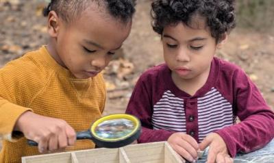 Two children playing and learning in nature