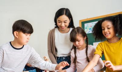 A teacher and students working with blocks