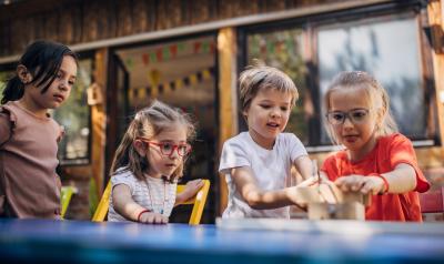 Young children working on a project together outside