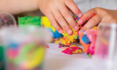 Plasticine modeling clay in children class. kids together play dough and  mold from plasticine in kindergarten or preschool. Group of four people.  Teaching modeling. They learn to live in a team. Stock