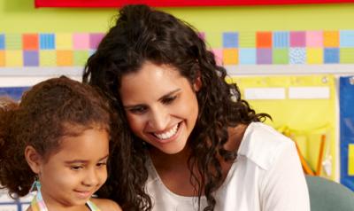 Teacher and preschool girl in a classroom