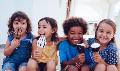 Group of diverse young children eating ice cream