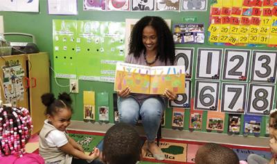 Jennifer Scott in her pre-K classroom, reading to hear students