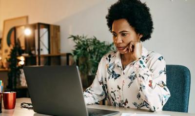 Woman at a computer staring at a screen