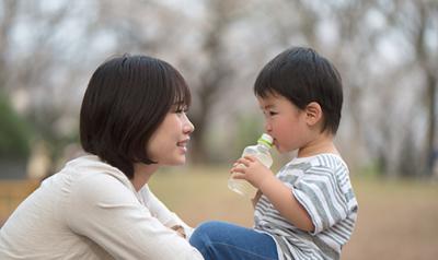 Mother and son sitting on a picnic table outside