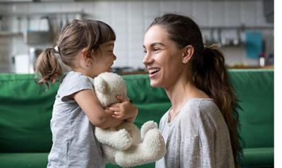 Mother and and a little girl holding a teddy bear