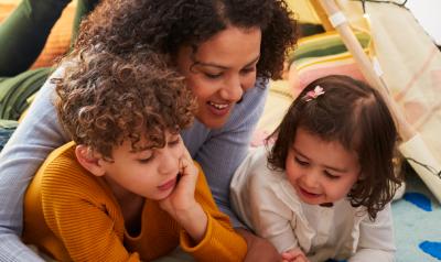 Mother and two children reading on the floor