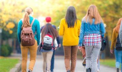 College students walking with backpacks