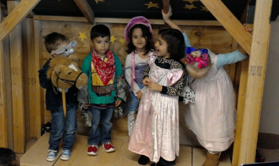A group of young children dresses up for their stage production.