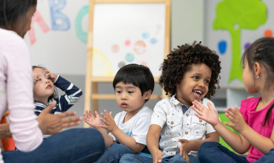 Children engage during circle time with a teacher.