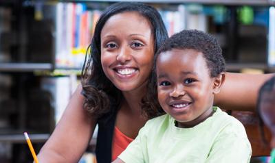 Educator with smiling child