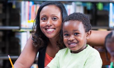 A teacher and a student smiling