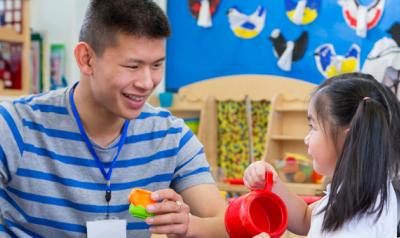 Teacher with student to encourage learning