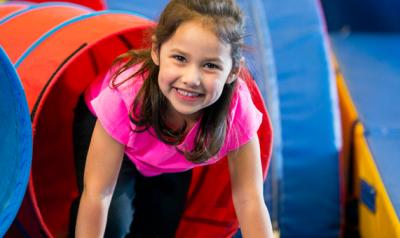 A child crawls through a tube