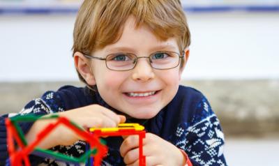 Boy building a structure with toys