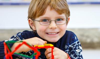 Young boy playing with plastic cubes