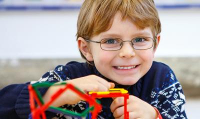 Young boy playing with plastic cubes