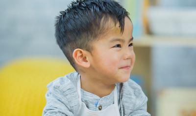 Two young boys at a table laughing