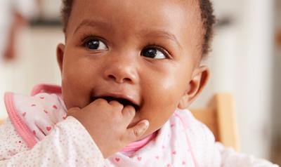 Toddler with hand in mouth