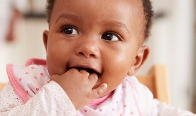 Toddler with hand in mouth